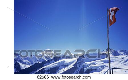 Low angle view of flag on snow covered mountain, Switzerland, Europe View Large Photo Image Stock Photograph - Low angle view of flag on snow covered mountain, Switzerland, Europe . Fotosearch