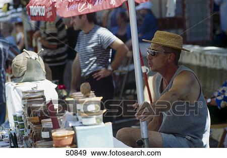 Stock Photo - Person in market, Ouveillan, France . Fotosearch