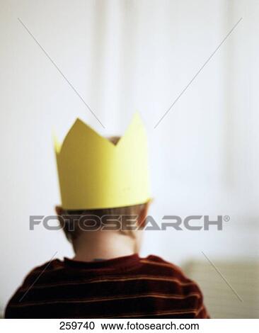 Stock Image - Rear view of a person wearing a crown . Fotosearch