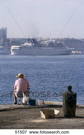 Rear view of fisherman at harbor, Valletta, Malta View Large Photo Image Stock Photo - Rear view of fisherman at harbor, Valletta, Malta . Fotosearch