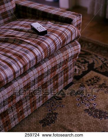 Picture - Remote control of television on couch . Fotosearch