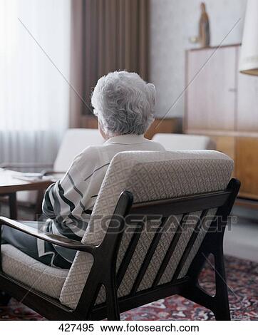 Senior woman sitting in chair, rear view View Large Photo Image Stock Photography - Senior woman sitting in chair, rear view . Fotosearch