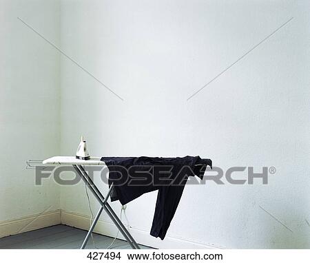 Shirt and iron on ironing board View Large Photo Image Picture - Shirt and iron on ironing board . Fotosearch