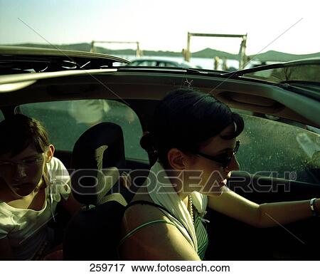 Side profile of woman driving car View Large Photo Image Stock Photo - Side profile of woman driving car . Fotosearch
