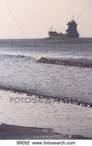 Silhouette of freighter ship in sea, Walcheren, Netherlands View Large Photo Image Stock Image - Silhouette of freighter ship in sea, Walcheren, Netherlands . Fotosearch