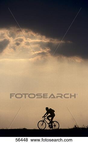 Silhouette of man cycling View Large Photo Image Stock Photo - Silhouette of man cycling . Fotosearch