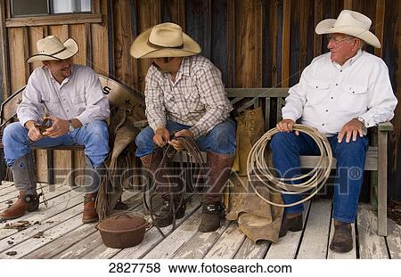 Three cowboys sitting side by side, full shot, USA View Large Photo Image Stock Photo - Three cowboys sitting side by side, full shot, USA . Fotosearch