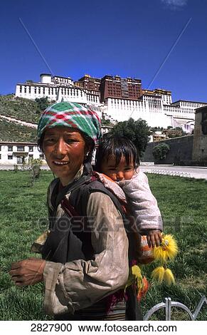 Stock Image - Tibetian with her child piggyback, China . Fotosearch
