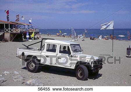 Stock Photography - Tourists and jeep on beach, Leucat Plage, France . Fotosearch