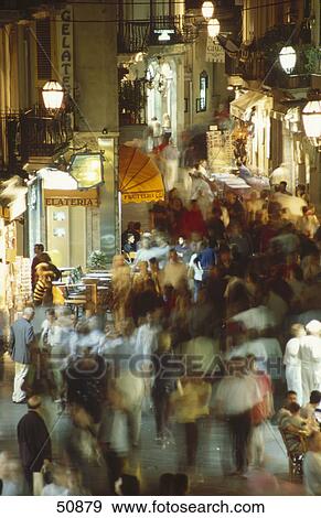 Tourists in market at night, Corso Umberto, Taormina, Sicily, Italy View Large Photo Image Stock Photo - Tourists in market at night, Corso Umberto, Taormina, Sicily, Italy . Fotosearch