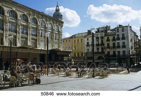Stock Photograph - Tourists sitting at town square, Hotel de Ville, Narbonne, France . Fotosearch