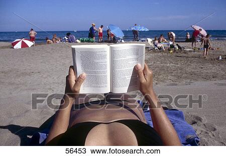 Woman reading book on beach View Large Photo Image Stock Image - Woman reading book on beach . Fotosearch