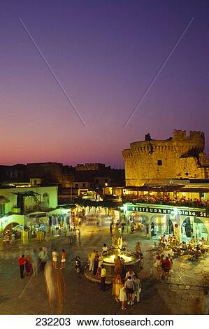Aerial view of tourists at town square, Ippokratous Square, Dodecanese Islands, Greece View Large Photo Image Stock Image - Aerial view of tourists at town square, Ippokratous Square, Dodecanese Islands, Greece . Fotosearch