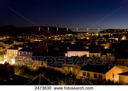Stock Image - Aerial view of town lit up at night, Midi-Pyrenees, France . Fotosearch