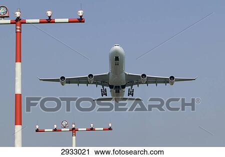 Airbus A340 landing, view from below View Large Photo Image Stock Image - Airbus A340 landing, view from below . Fotosearch
