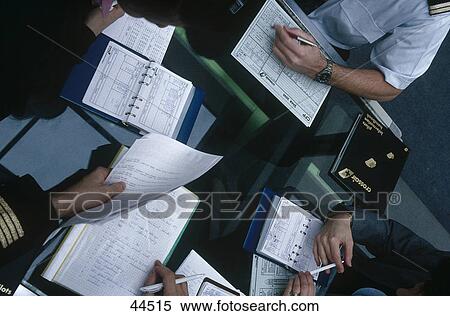 Stock Photography - Airlines employees planning flight schedule . Fotosearch