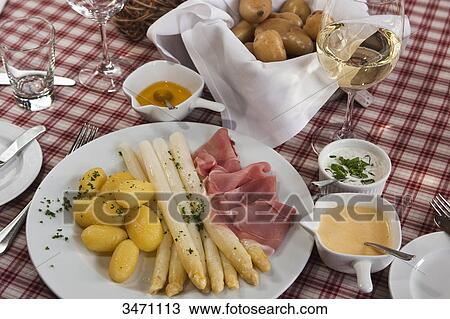Stock Image - Asparagus with ham and potatoes . Fotosearch