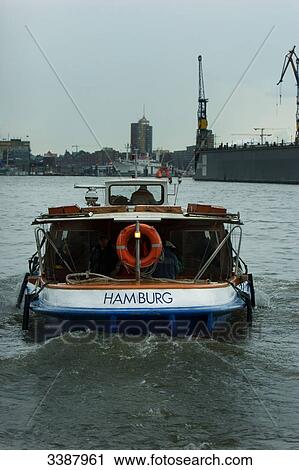 Barge driving towards Hamburg harbour, Germany, rear view View Large Photo Image Stock Image - Barge driving towards Hamburg harbour, Germany, rear view . Fotosearch