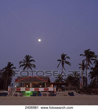 Beach cottage lit up at dusk, India View Large Photo Image Stock Image - Beach cottage lit up at dusk, India . Fotosearch