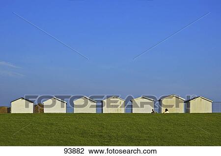 Beach huts in row on beach, West Sussex, England View Large Photo Image Stock Image - Beach huts in row on beach, West Sussex, England . Fotosearch