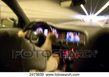 Stock Photo - Blurred view of man driving car . Fotosearch