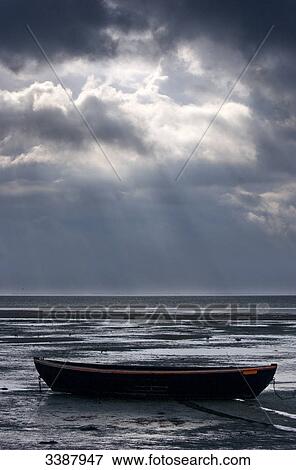 Boat at low tide on North Sea, Sylt, Germany View Large Photo Image Stock Photo - Boat at low tide on North Sea, Sylt, Germany . Fotosearch