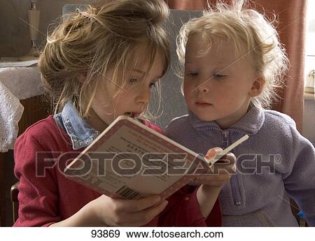 Boy and girl reading a book View Large Photo Image Stock Photo - Boy and girl reading a book . Fotosearch