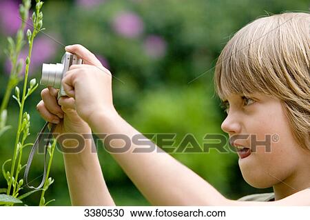 Boy photographing flower View Large Photo Image Stock Image - Boy photographing flower . Fotosearch