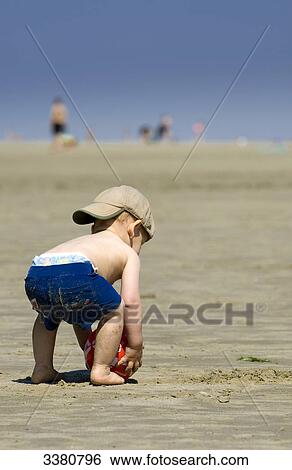 Stock Photograph - Boy playing at beach, Sankt Peter-Ording, Schleswig-Holstein, Germany . Fotosearch