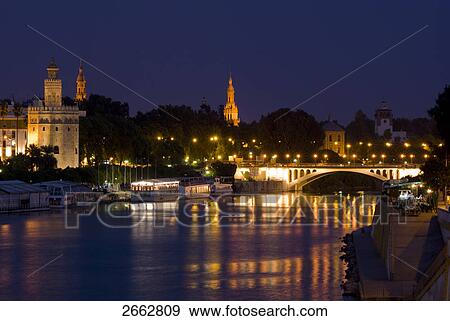 Bridge across river lit up at night View Large Photo Image Stock Photo - Bridge across river lit up at night . Fotosearch