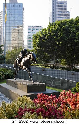 Stock Image - Bronze statue of jockey on pedestal, Hong Kong, China . Fotosearch