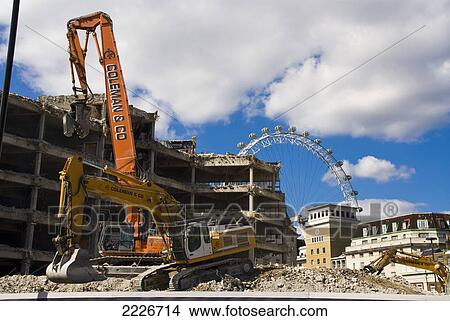 Building under construction with ferris wheel in background, Millennium Wheel, London, England View Large Photo Image Picture - Building under construction with ferris wheel in background, Millennium Wheel, London, England . Fotosearch