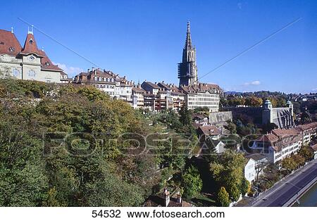 Stock Image - Buildings and bell tower in town against blue sky, Berne, Switzerland . Fotosearch