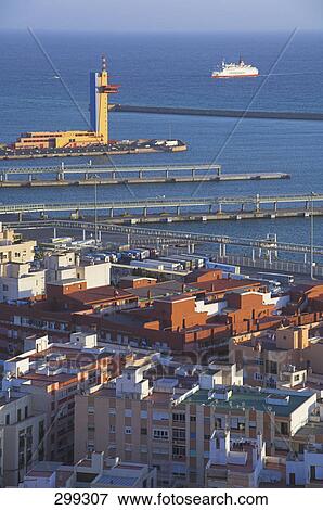 Stock Photo - Buildings at harbor in city, Alcazaba, Almeria, Andalusia, Spain . Fotosearch