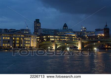Stock Image - Buildings on waterfront, Thames River, London Borough of Southwark, Greater London, England . Fotosearch