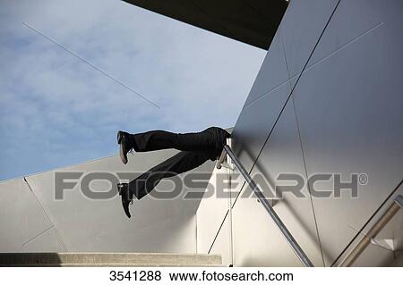 Businessman falling over banister View Large Photo Image Stock Photo - Businessman falling over banister . Fotosearch