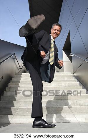 Businessman kicking with his foot View Large Photo Image Picture - Businessman kicking with his foot . Fotosearch