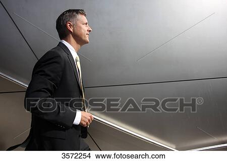 Businessman on the go, profile View Large Photo Image Picture - Businessman on the go, profile . Fotosearch