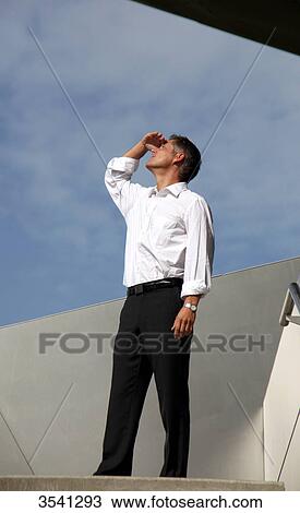 Businessman outdoors looking up View Large Photo Image Stock Image - Businessman outdoors looking up . Fotosearch