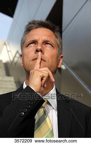 Stock Photo - Businessman outdoors thinking . Fotosearch