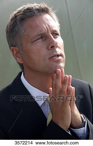Picture - Businessman outdoors with hands folded . Fotosearch