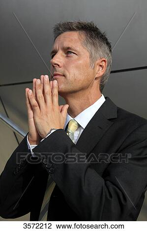 Businessman outdoors with hands folded View Large Photo Image Stock Image - Businessman outdoors with hands folded . Fotosearch