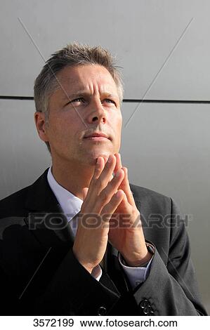 Businessman outdoors with hands folded View Large Photo Image Stock Photo - Businessman outdoors with hands folded . Fotosearch