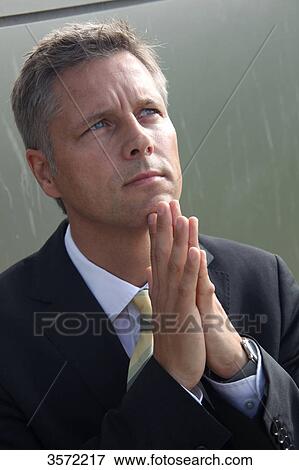 Stock Photo - Businessman outdoors with hands folded . Fotosearch