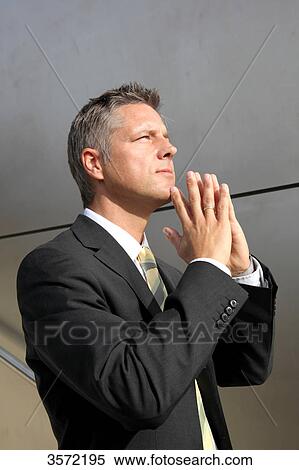 Businessman outdoors with hands folded View Large Photo Image Stock Photography - Businessman outdoors with hands folded . Fotosearch