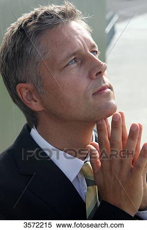 Businessman outdoors with hands folded View Large Photo Image Stock Photography - Businessman outdoors with hands folded . Fotosearch