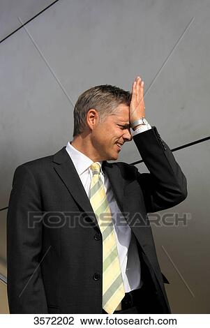 Stock Image - Businessman putting his hand on his head . Fotosearch