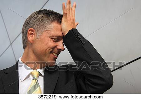 Stock Photo - Businessman putting his hand on his head . Fotosearch