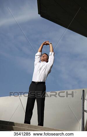 Businessman raising his arms outdoors View Large Photo Image Stock Photography - Businessman raising his arms outdoors . Fotosearch