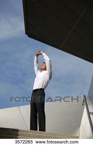 Stock Photography - Businessman raising his arms outdoors . Fotosearch
